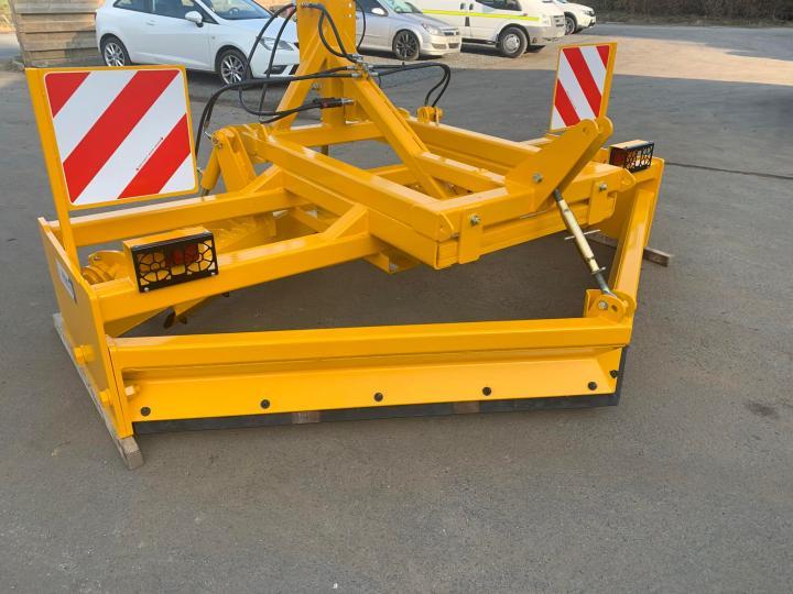 Gravel road grader with rear lights and marker boards